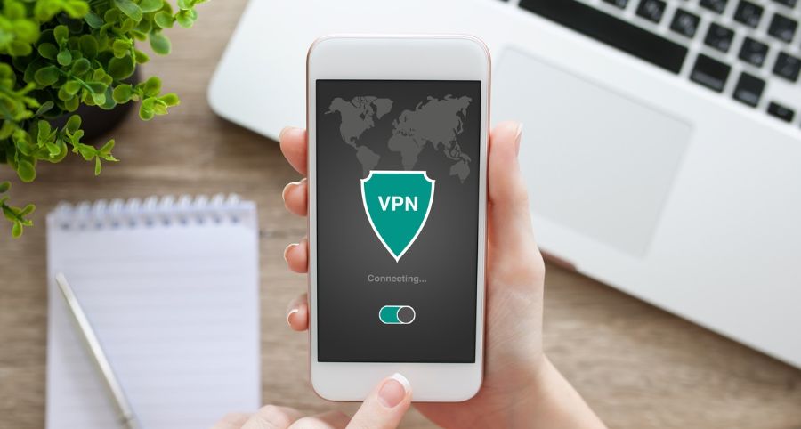 man holding mobile phone with vpn running